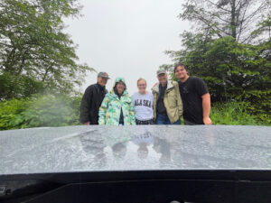 The rain-soaked group posing in front of a cloud-shrouded Mt. Edgecumbe for GC75MP7, an Earthcache by the same name. Don’t worry, the CO still lets you log it even if you can’t see it!