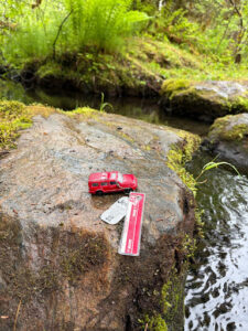 A 2007 Jeep Travel Bug named “Situk River” poses next to its namesake on June 17th, 2026