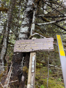 Signs to the public use cabins and a view of the glacial lake. 